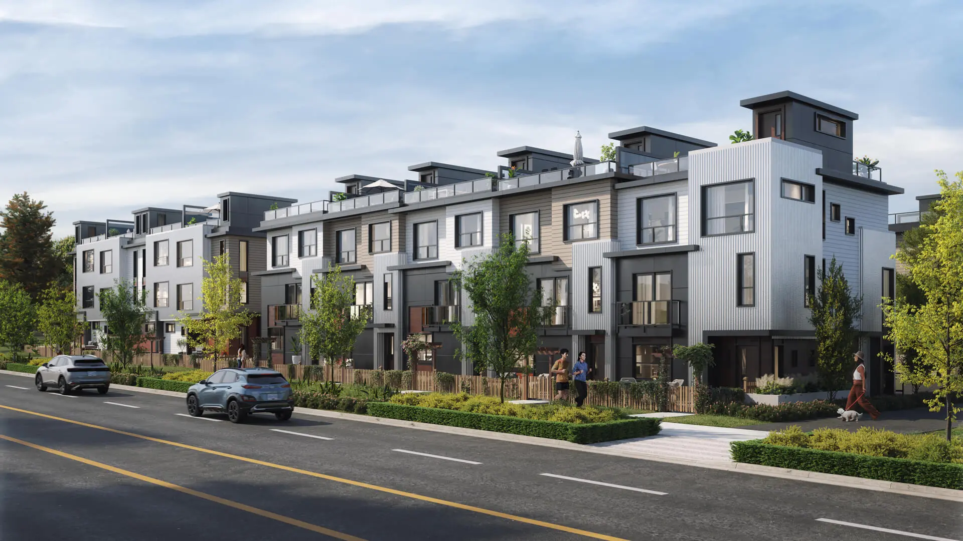 Modern three-story townhouse complex with rooftop terraces, trees, parked cars, and pedestrians on a sunny day, showcasing well-maintained grounds and attentive property maintenance.